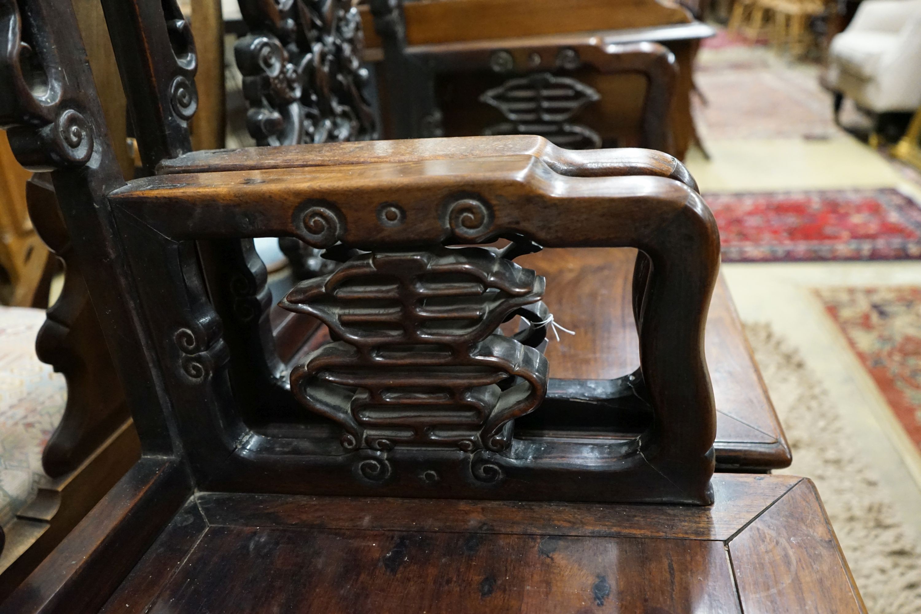 A pair of Chinese carved hongmu elbow chairs (a.f.), width 65cm, depth 48cm, height 96cm